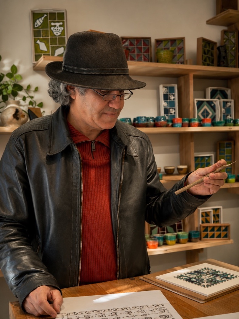 Tarek, the calligrapher, with a reed pen